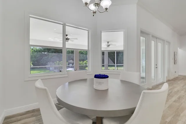 a view of a dining room with a table and chairs