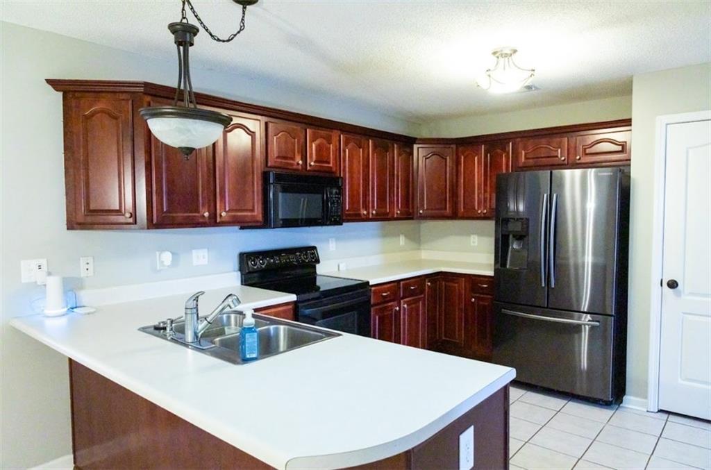 28 Papershell Drive Fort Valley, GA 31030 - Photo 14 of 64 a kitchen with stainless steel appliances granite countertop a refrigerator a sink a stove and cabinets
