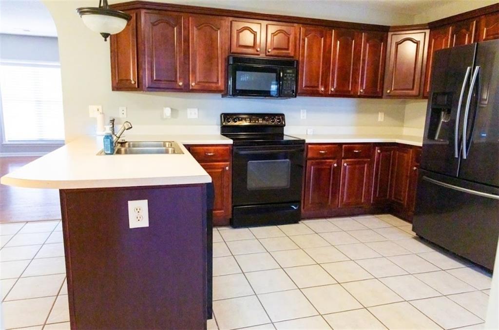 28 Papershell Drive Fort Valley, GA 31030 - Photo 15 of 64 a kitchen with stainless steel appliances a refrigerator stove top oven and sink