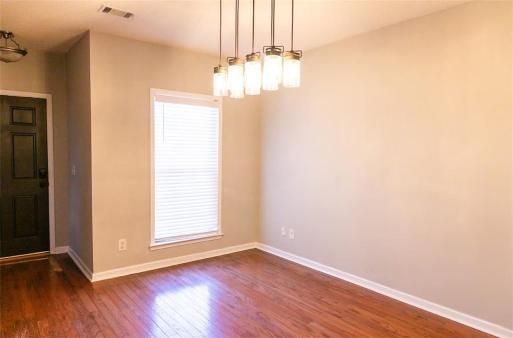 28 Papershell Drive Fort Valley, GA 31030 - Photo 19 of 64 an empty room with wooden floor chandelier and windows