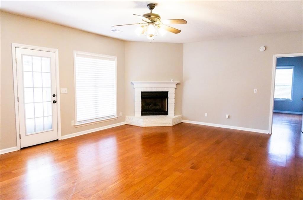 28 Papershell Drive Fort Valley, GA 31030 - Photo 42 of 64 an empty room with wooden floor fireplace and windows