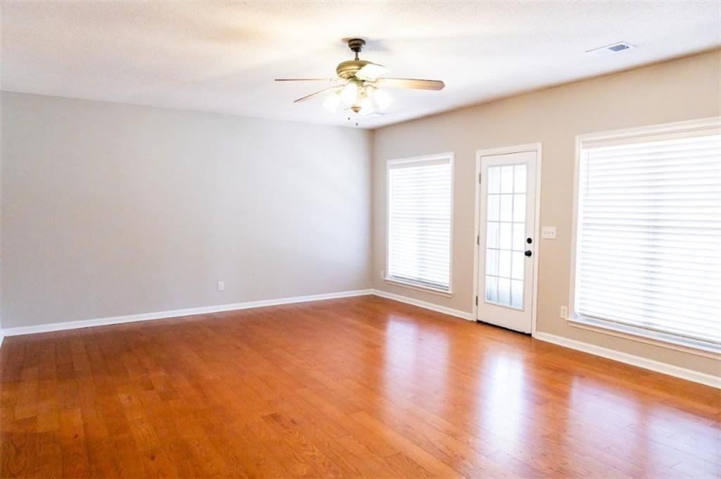 28 Papershell Drive Fort Valley, GA 31030 - Photo 44 of 64 an empty room with wooden floor chandelier fan and windows
