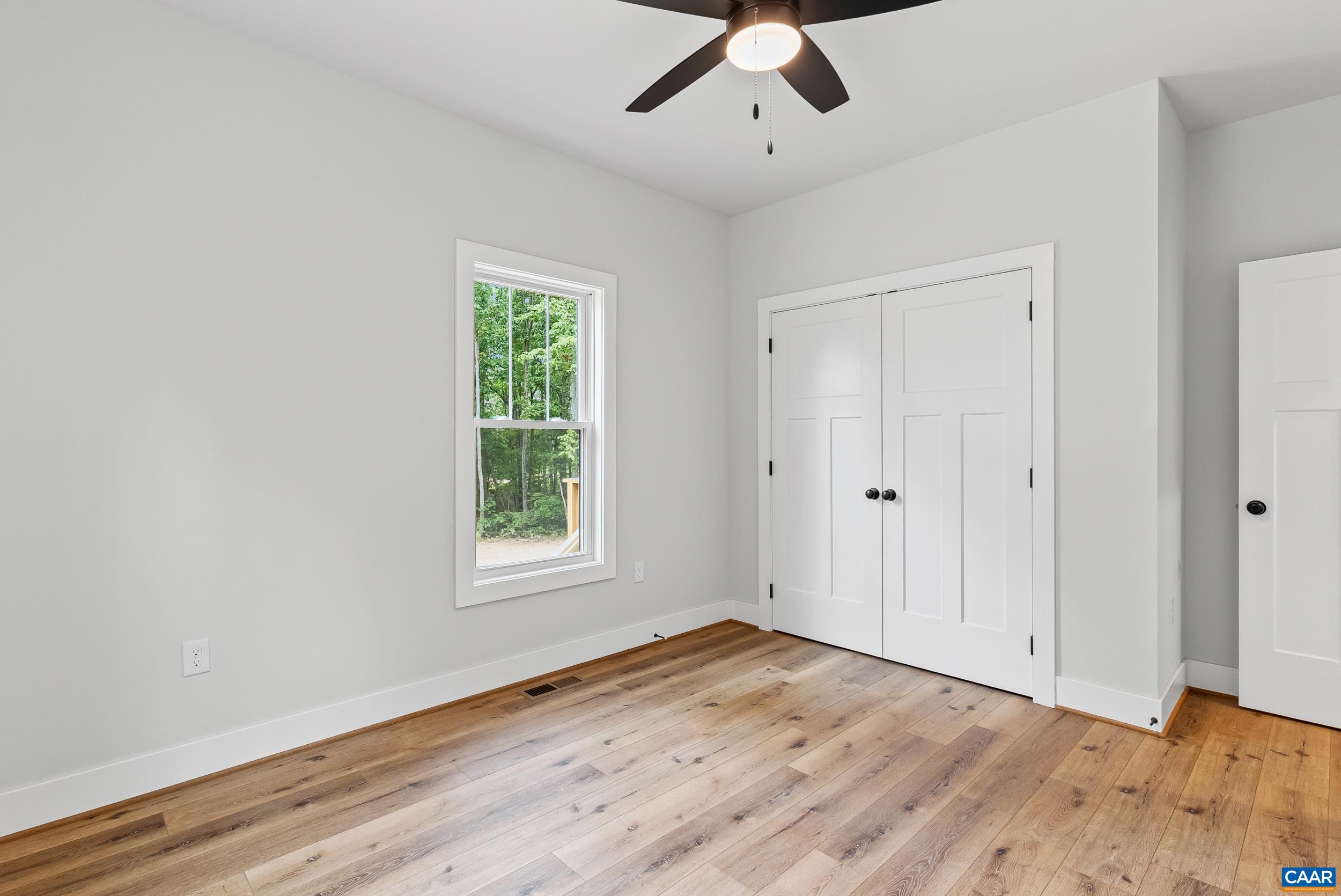 594 Community Road Dillwyn, VA 23936 - Photo 26 of 48 a view of empty room with wooden floor and fan
