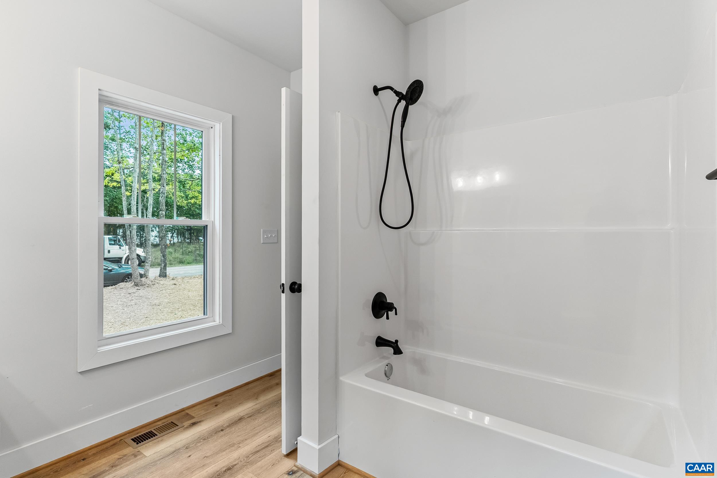 594 Community Road Dillwyn, VA 23936 - Photo 33 of 48 a bathroom with a bath tub and a shower