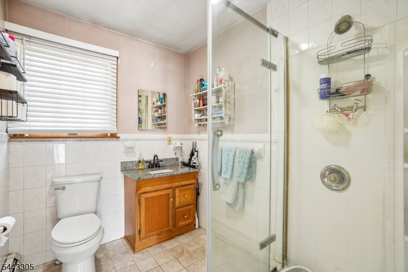 267 Kings Road Madison, NJ 07940 - Photo 15 of 37 a bathroom with a granite countertop sink toilet and shower
