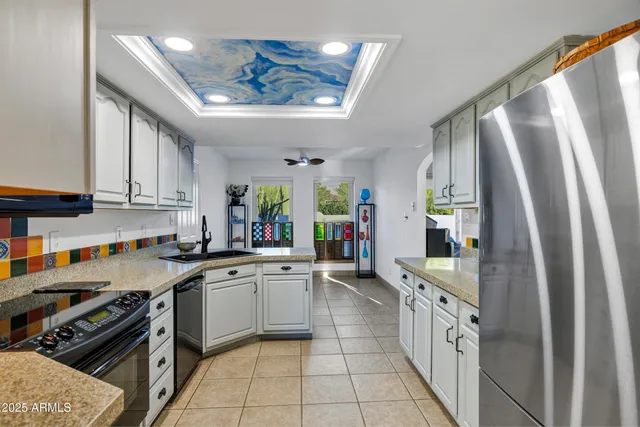 a kitchen with stainless steel appliances a sink stove and cabinets