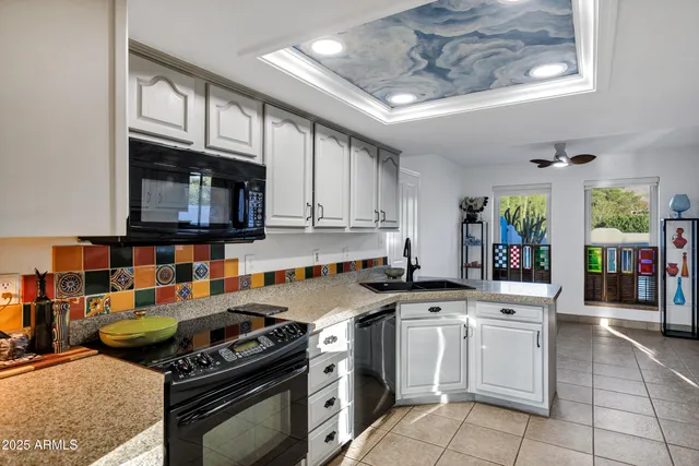 a kitchen with stainless steel appliances granite countertop a stove and cabinets