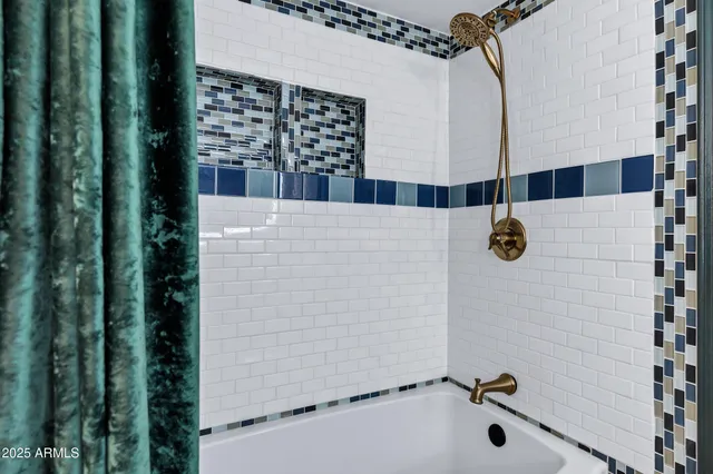 a bathroom with a shower and a sink