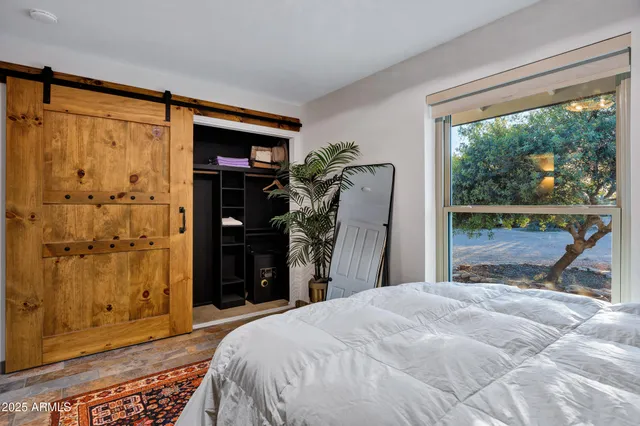 a bedroom with a bed and a mirror