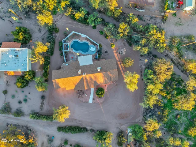 an aerial view of a house with a swimming pool