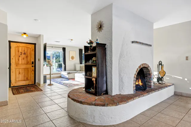 a living room with fireplace furniture and a window