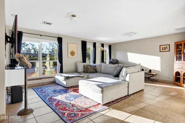 a living room with furniture and a rug