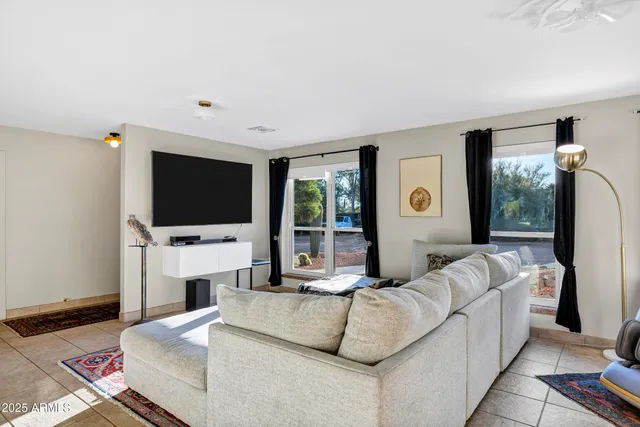 a living room with fireplace furniture and a flat screen tv