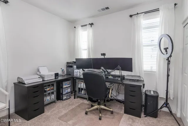 a view of a workspace with furniture