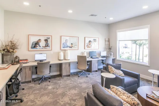 a view of a livingroom with workspace and a couch