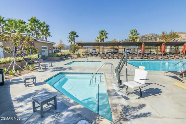 a view of a swimming pool with outdoor seating