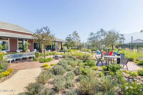 a view of house with swimming pool and seating area