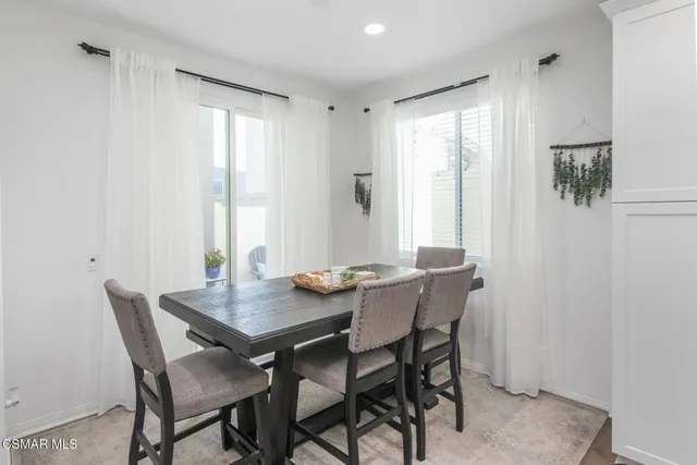 a view of a dining room with furniture and window