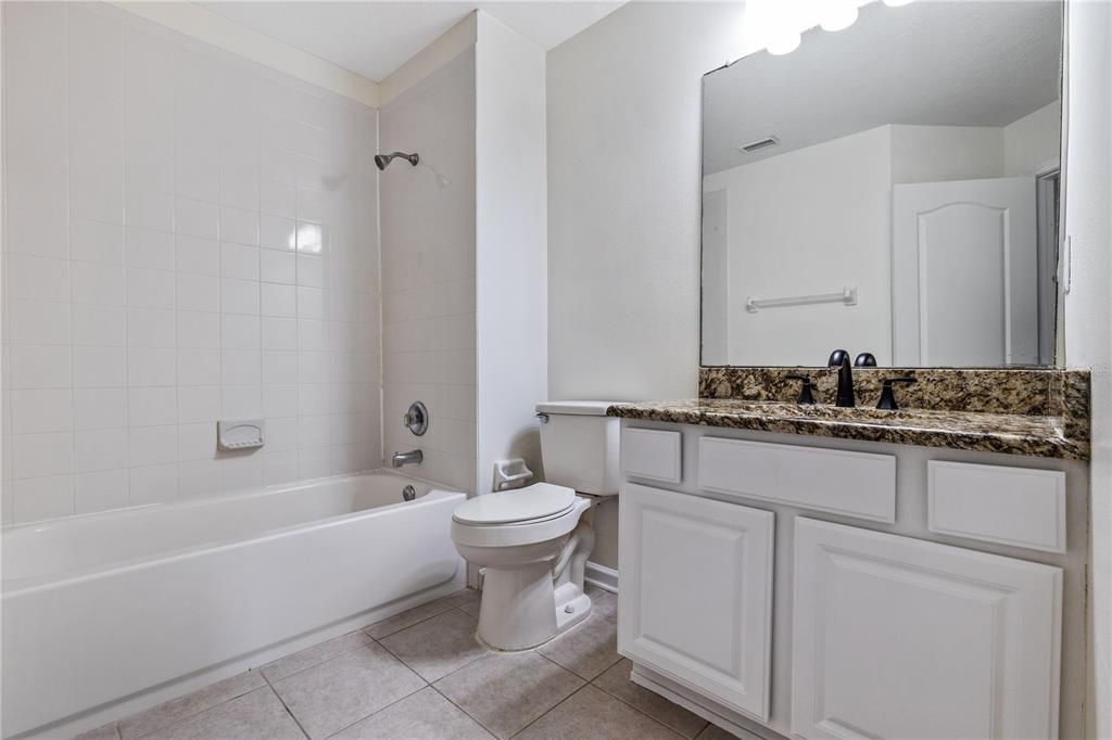 8520 Sandy Beach Street Tampa, FL 33634 - Photo 17 of 25 a bathroom with a toilet a sink and bathtub