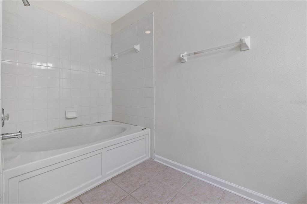 8520 Sandy Beach Street Tampa, FL 33634 - Photo 18 of 25 a bathroom with a bathtub
