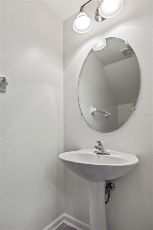 8520 Sandy Beach Street Tampa, FL 33634 - Photo 23 of 25 a bathroom with a sink and mirror