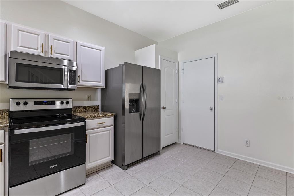 8520 Sandy Beach Street Tampa, FL 33634 - Photo 5 of 25 a kitchen with a refrigerator stove and microwave