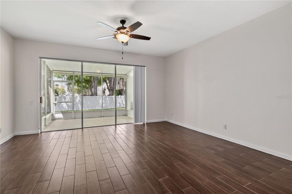 8520 Sandy Beach Street Tampa, FL 33634 - Photo 7 of 25 wooden floor in an empty room with a window