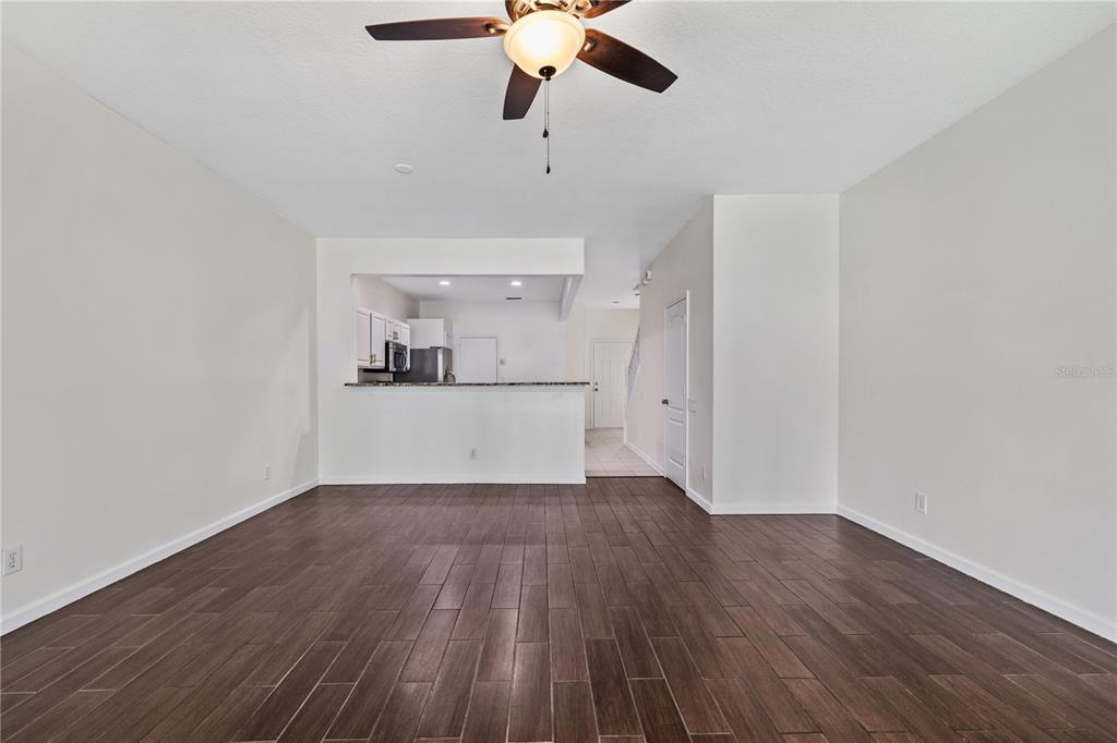 8520 Sandy Beach Street Tampa, FL 33634 - Photo 8 of 25 a view of a kitchen with a dishwasher cabinets and wooden floor