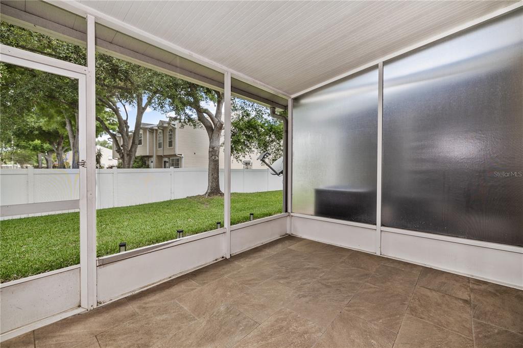 8520 Sandy Beach Street Tampa, FL 33634 - Photo 10 of 25 a view of an empty room with floor to ceiling windows with garden