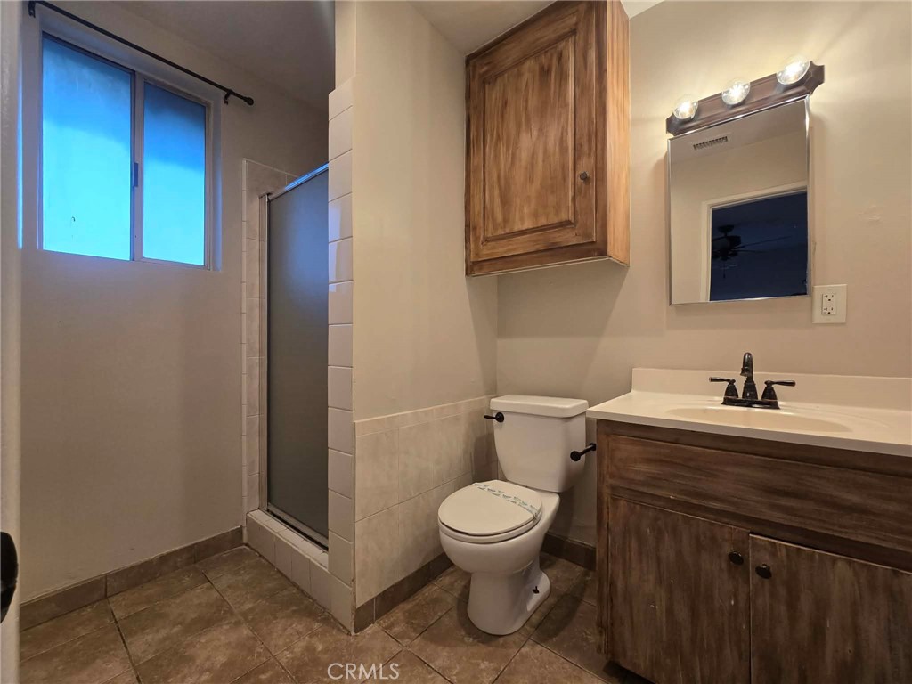 607 Sixth Street Norco, CA 92860 - Photo 12 of 17 a bathroom with a toilet a sink and mirror