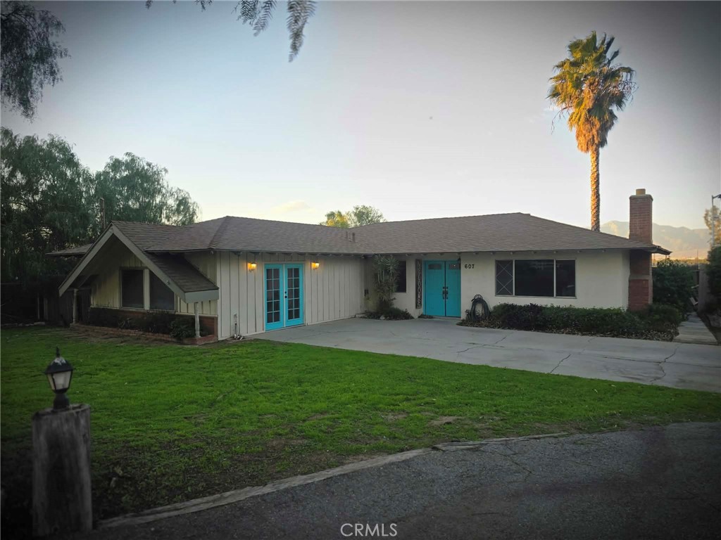 607 Sixth Street Norco, CA 92860 - Photo 14 of 17 a view of a yard in front of a house with large trees