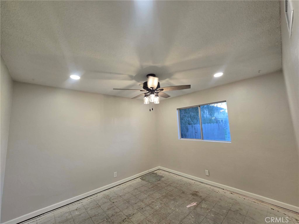 607 Sixth Street Norco, CA 92860 - Photo 15 of 17 en empty room with windows and fan