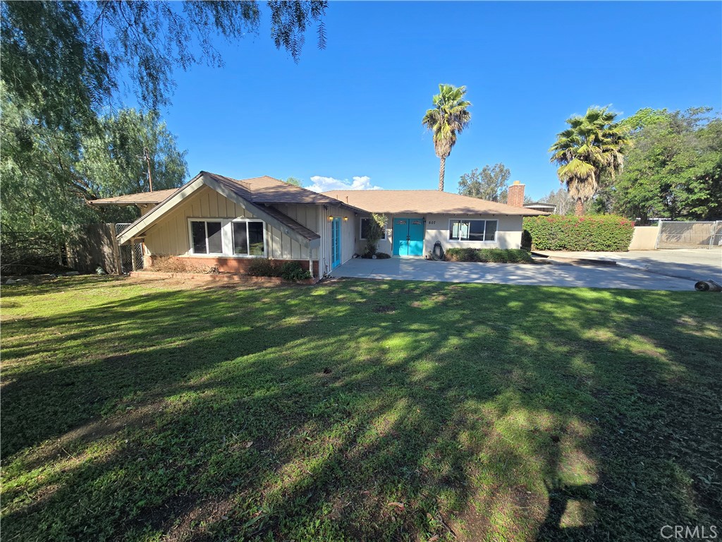 607 Sixth Street Norco, CA 92860 - Photo 2 of 33 a front view of a house with a garden