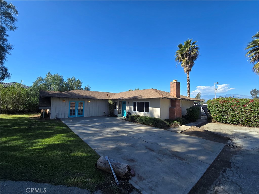607 Sixth Street Norco, CA 92860 - Photo 33 of 33 a front view of a house with a garden