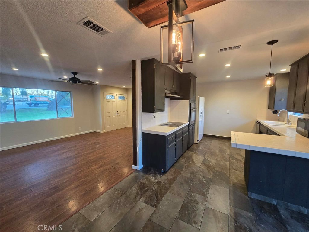 607 Sixth Street Norco, CA 92860 - Photo 6 of 17 a large room with a lot of counter space and wooden floor