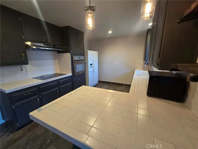 a kitchen with a sink and a stove top oven