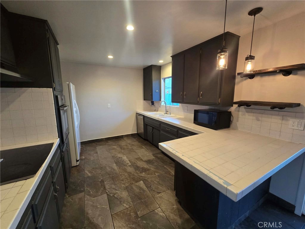 607 Sixth Street Norco, CA 92860 - Photo 9 of 17 a kitchen with stainless steel appliances cabinets and wooden floor