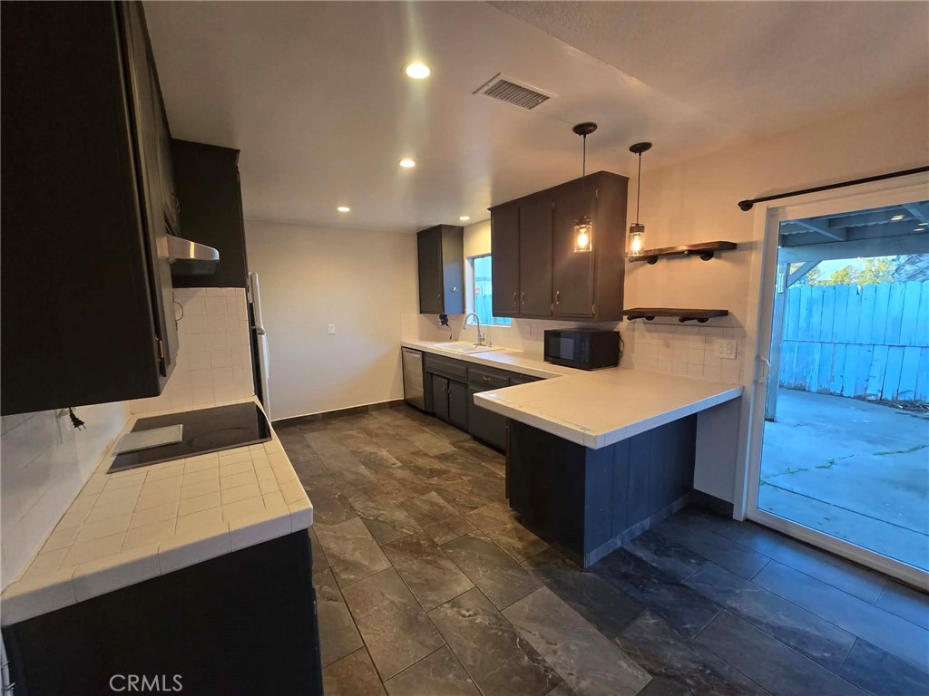607 Sixth Street Norco, CA 92860 - Photo 10 of 17 a kitchen with a stove refrigerator and sink