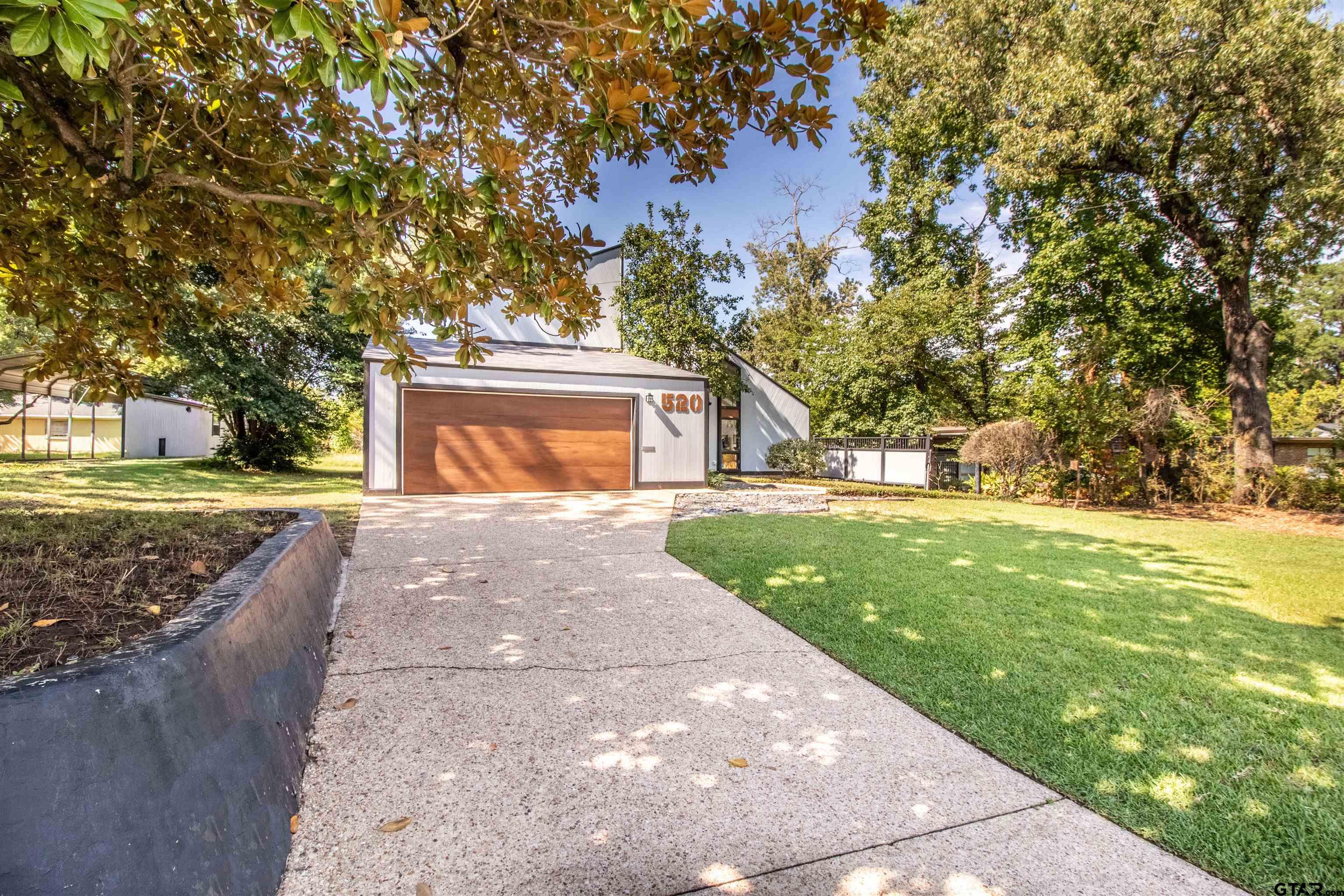 520 East Lake Street Tyler, TX 75701 - Photo 2 of 41 a front view of a house with a yard and trees