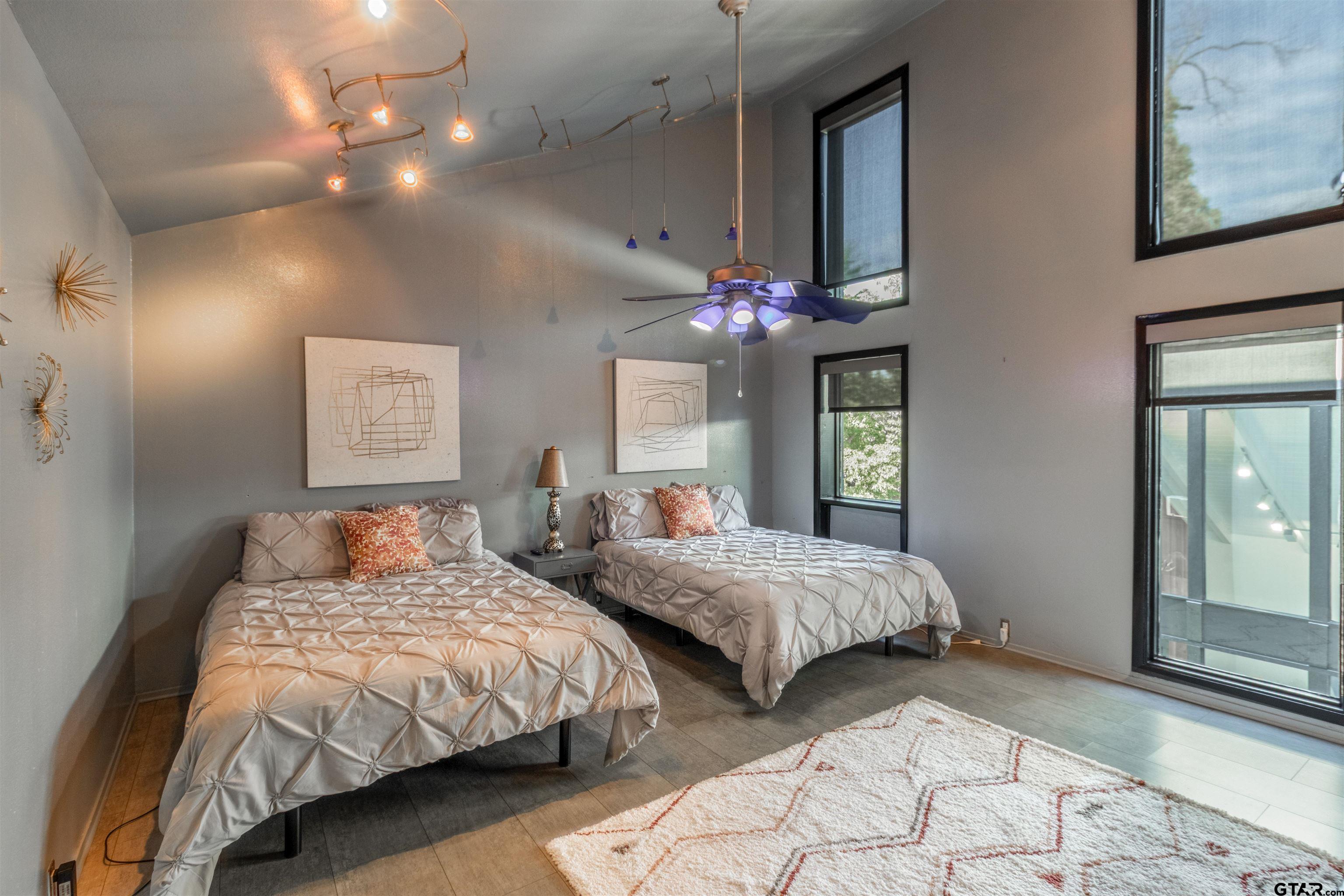 520 East Lake Street Tyler, TX 75701 - Photo 22 of 41 a bedroom with two large bed and a chandelier