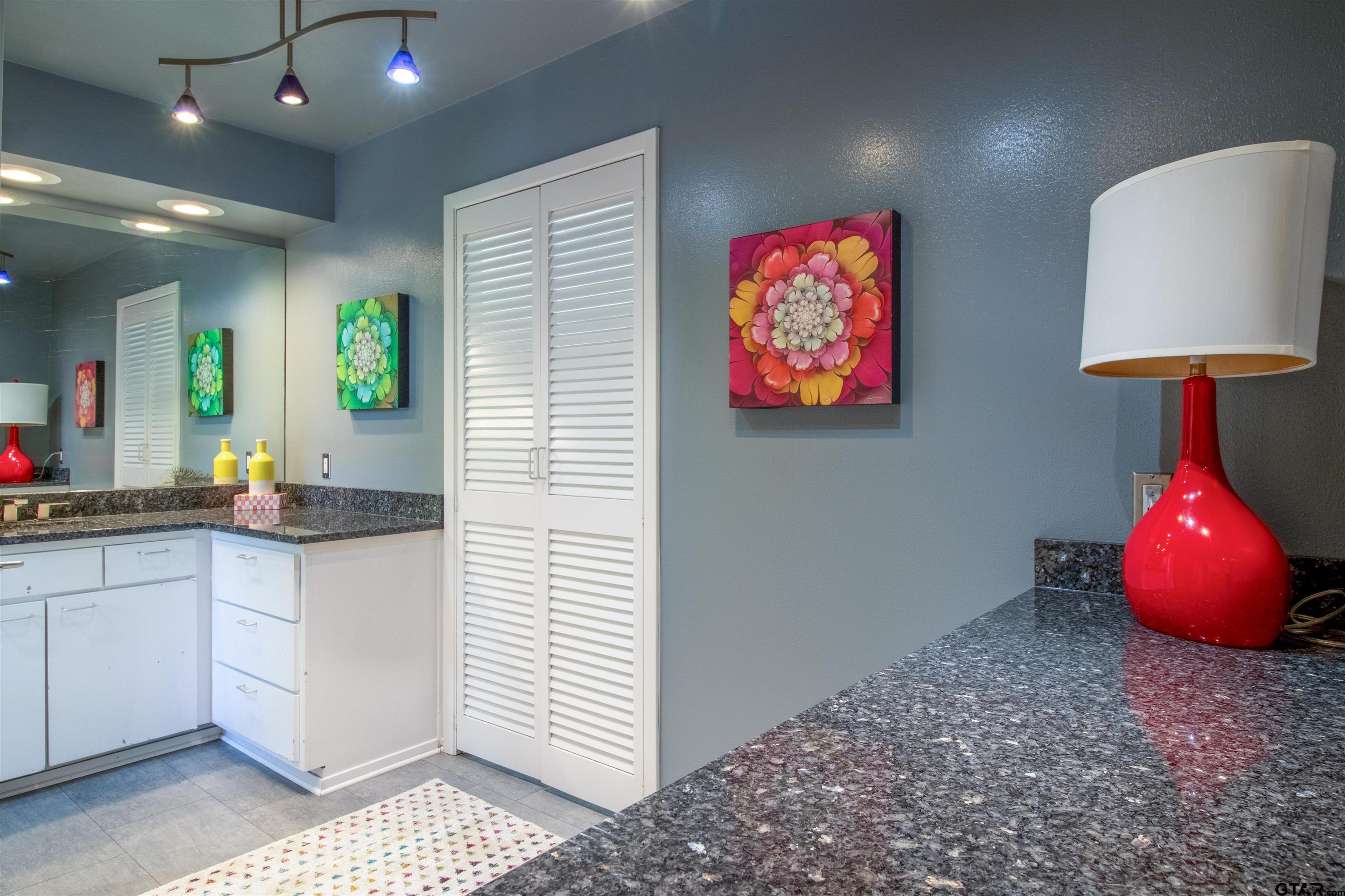 520 East Lake Street Tyler, TX 75701 - Photo 24 of 41 a bathroom with a sink a faucet a mirror and a lamp
