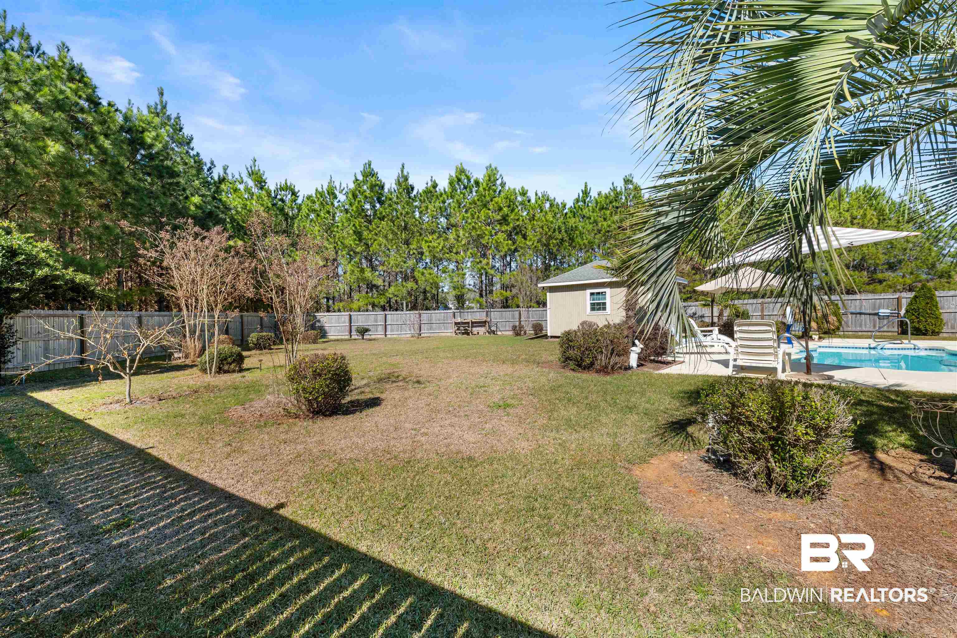 1850 Arcadia Drive Foley, AL 36535 - Photo 38 of 44 View of yard featuring a fenced in pool, a fenced backyard, and an outdoor structure