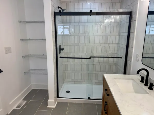 a bathroom with a shower and a sink