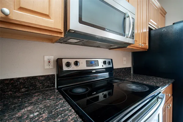 a stove top oven sitting inside of a kitchen