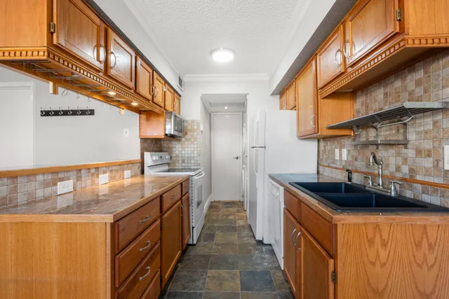 a kitchen with stainless steel appliances granite countertop a stove and a sink