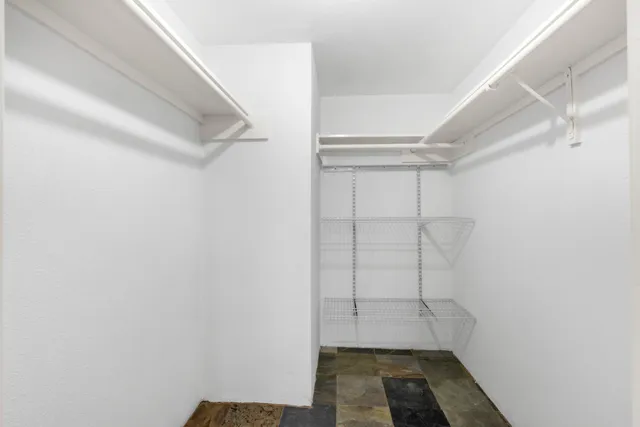 a car parked in front of a white house