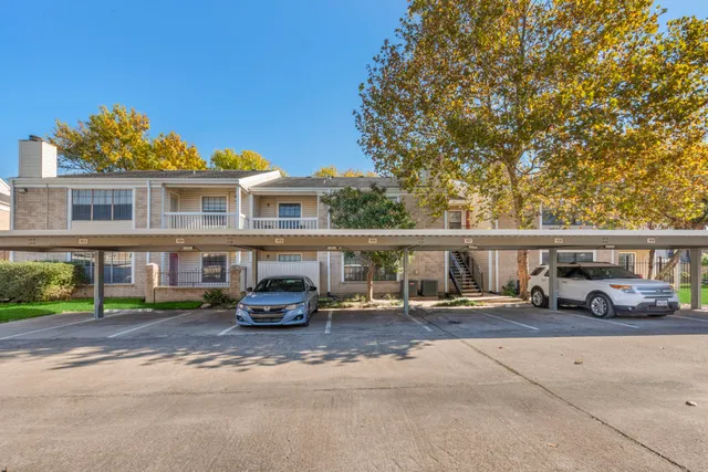 a view of a house with a patio and a yard