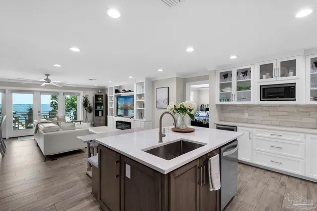 a large bedroom with a bed and flat screen tv