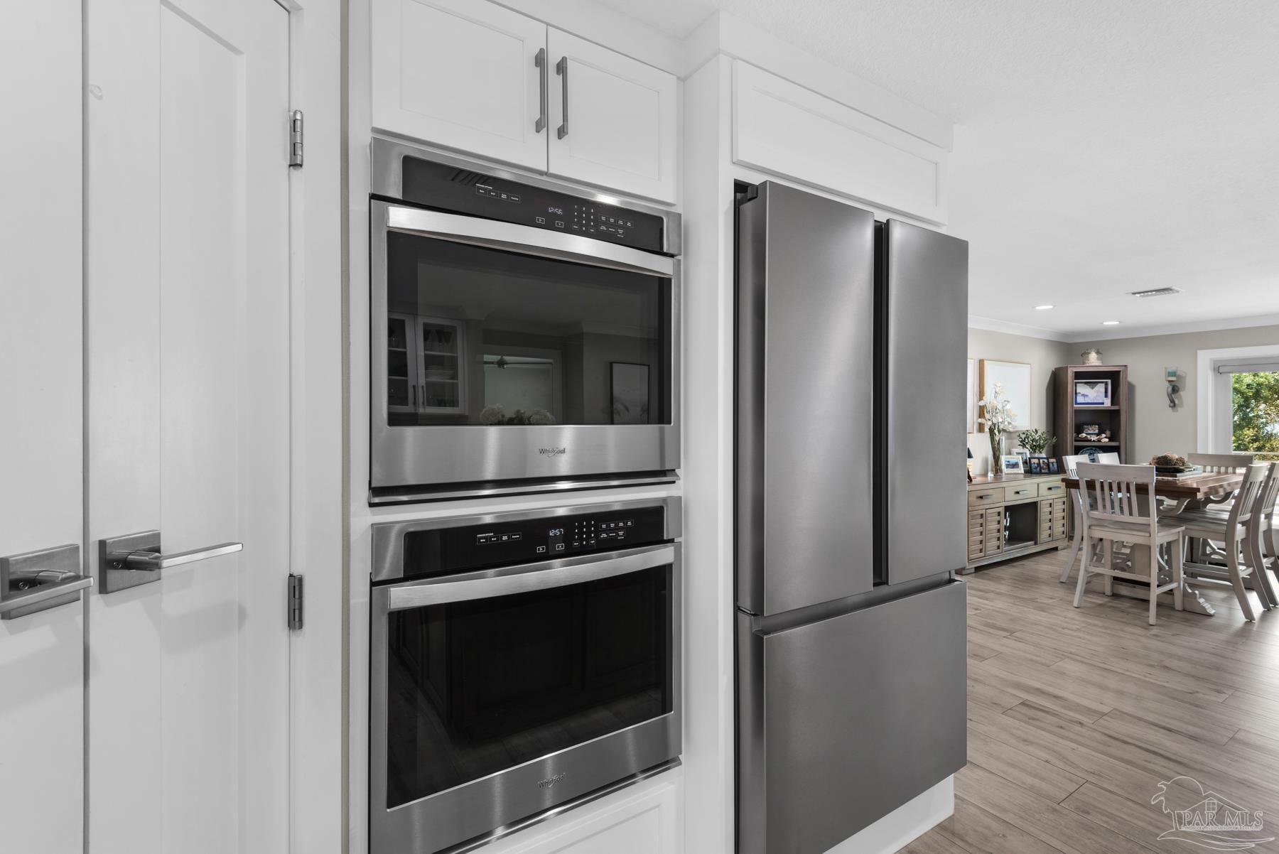 2829 Bay Street Gulf Breeze, FL 32563 - Photo 17 of 69 a kitchen with granite countertop stainless steel appliances and wooden floor