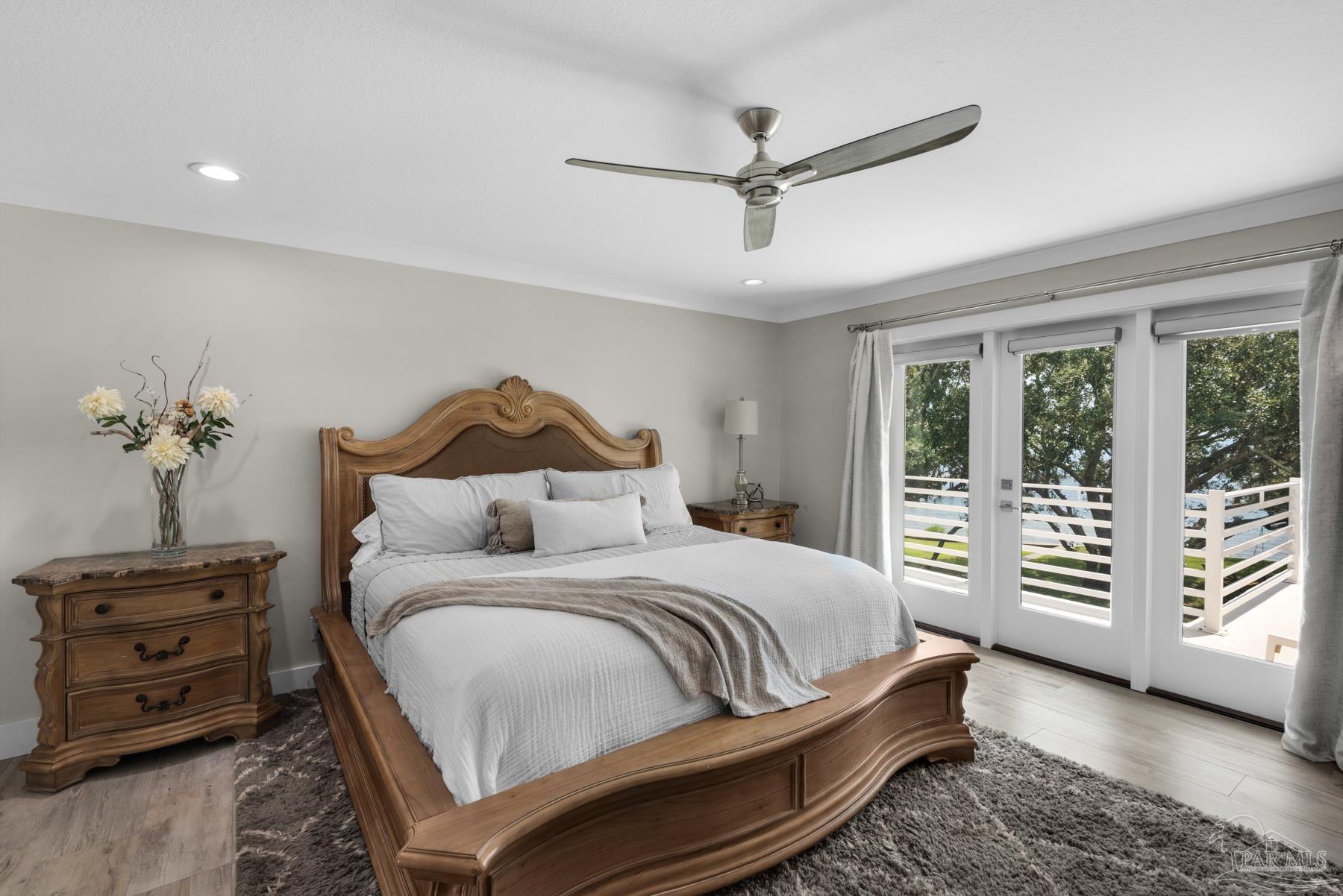 2829 Bay Street Gulf Breeze, FL 32563 - Photo 20 of 69 a bedroom with a bed a dresser and a chandelier